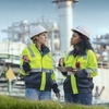 Experts for sustainability initiatives in front of a power plant